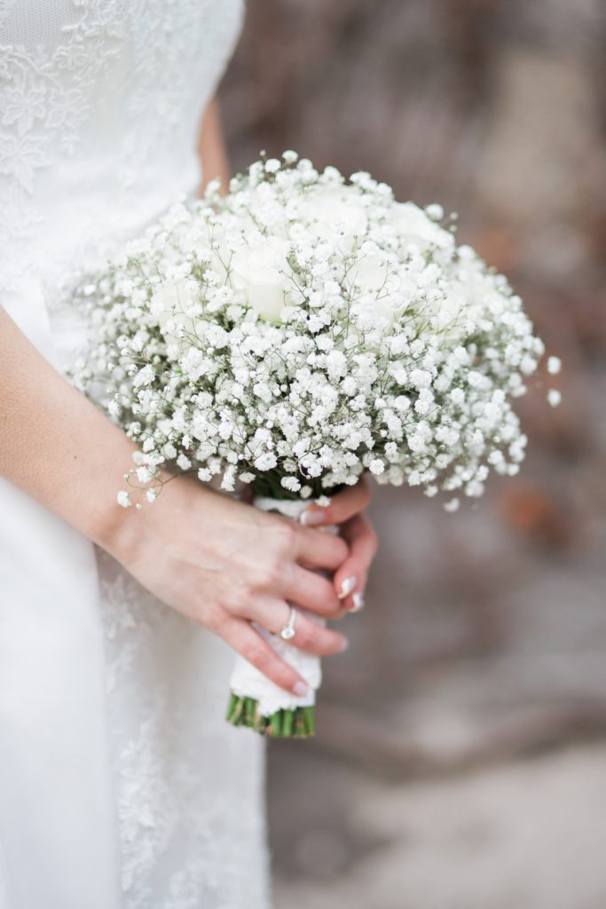 Pure white bridal bouquet with roses at Carlowrie Castle in Edinburgh, Scotland