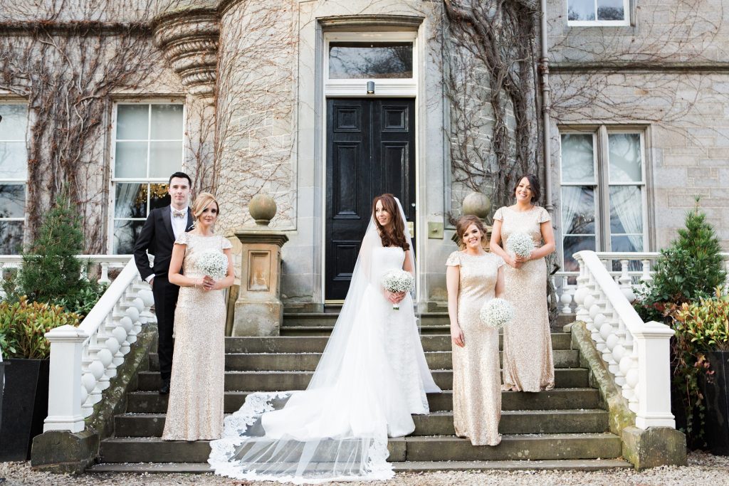 Bride with bridesmaids in gold sequin gowns from Sorella Vita at a wedding at Carlowrie Castle in Edinburgh, Scotland