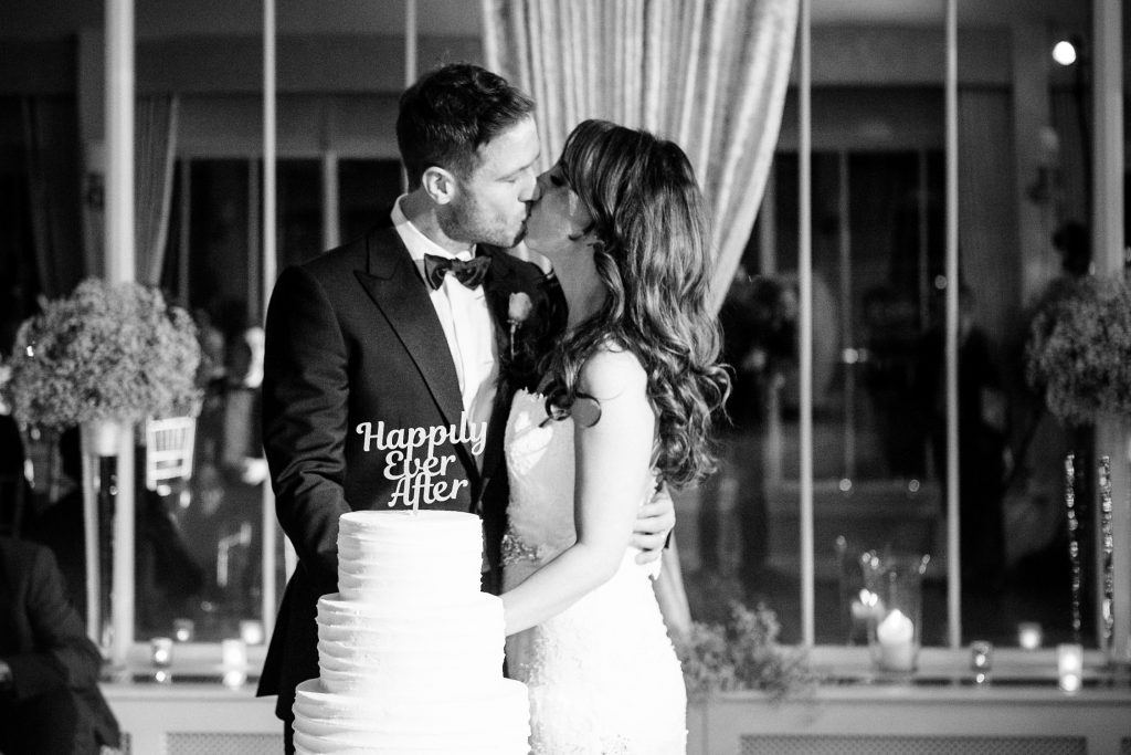 Cutting of the cake at wedding at Carlowrie Castle in Edinburgh, Scotland