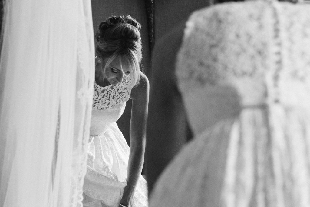 Bridal prep at Carlowrie Castle Scottish castle wedding venue featuring bride wearing a lace Caroline Castligliano wedding gown