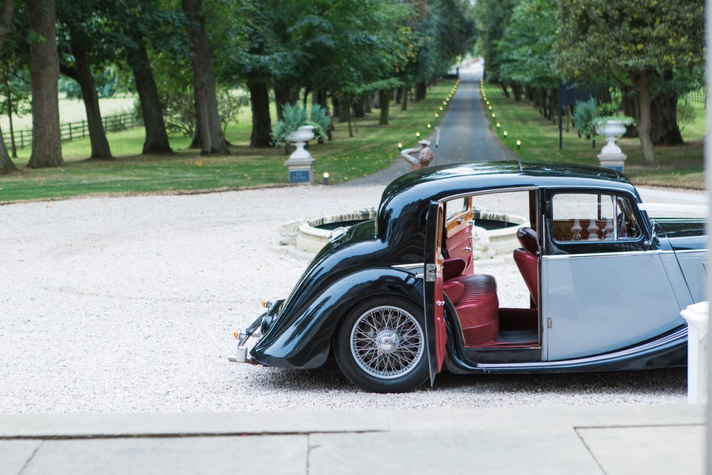 Vintage Jaguar wedding car with red leather interior in Edinburgh for a wedding at Carlowrie Castle Scotland.