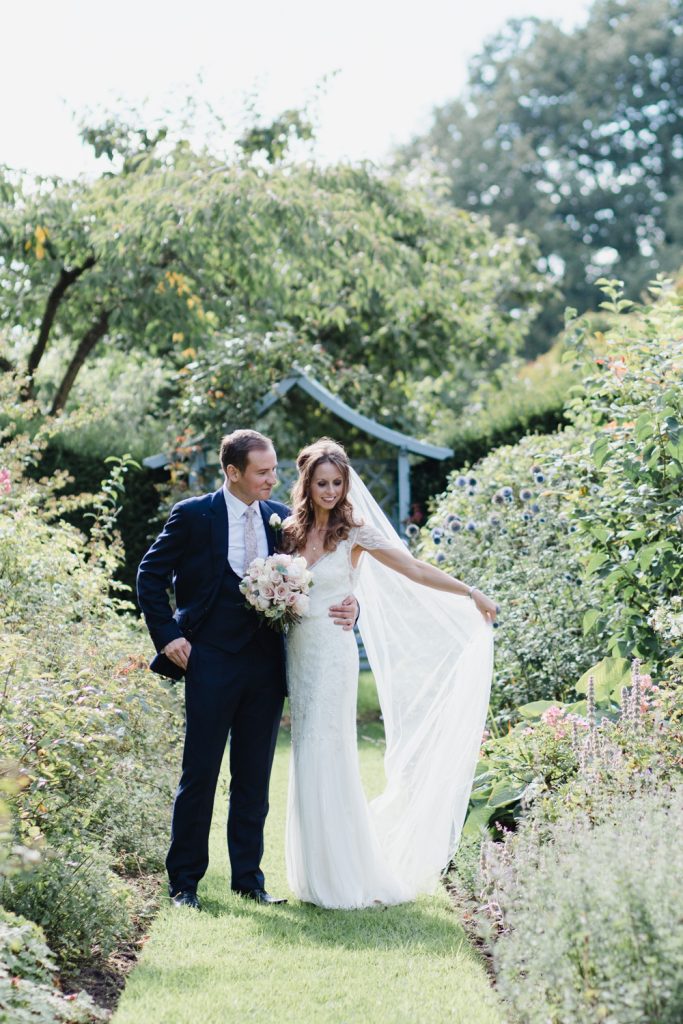 Bride and Groom portraits in the gardens at Dorfold Hall, Cheshire by Fine Art Wedding Photographer in Cheshire.