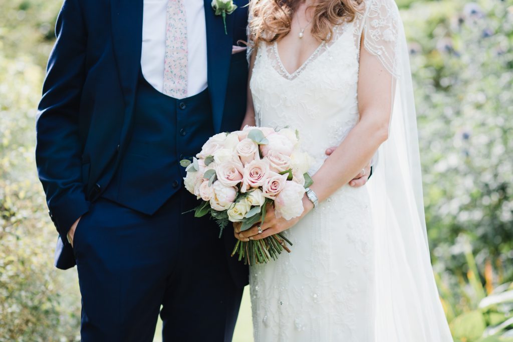 Dorfold Hall Wedding Photography featuring bride and groom portraits in the rose garden.
