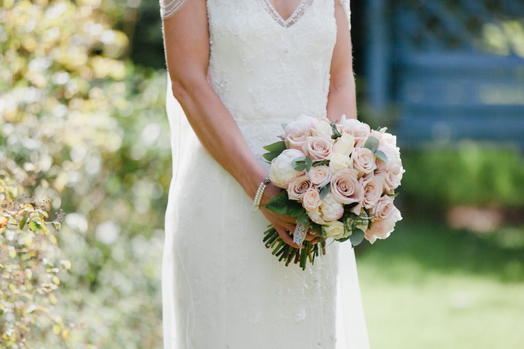 Bridal bouquet at Dorfold Hall wedding. Bridal portrait details in the rose garden at Dorfold Hall with a Jenny Packham wedding dress.