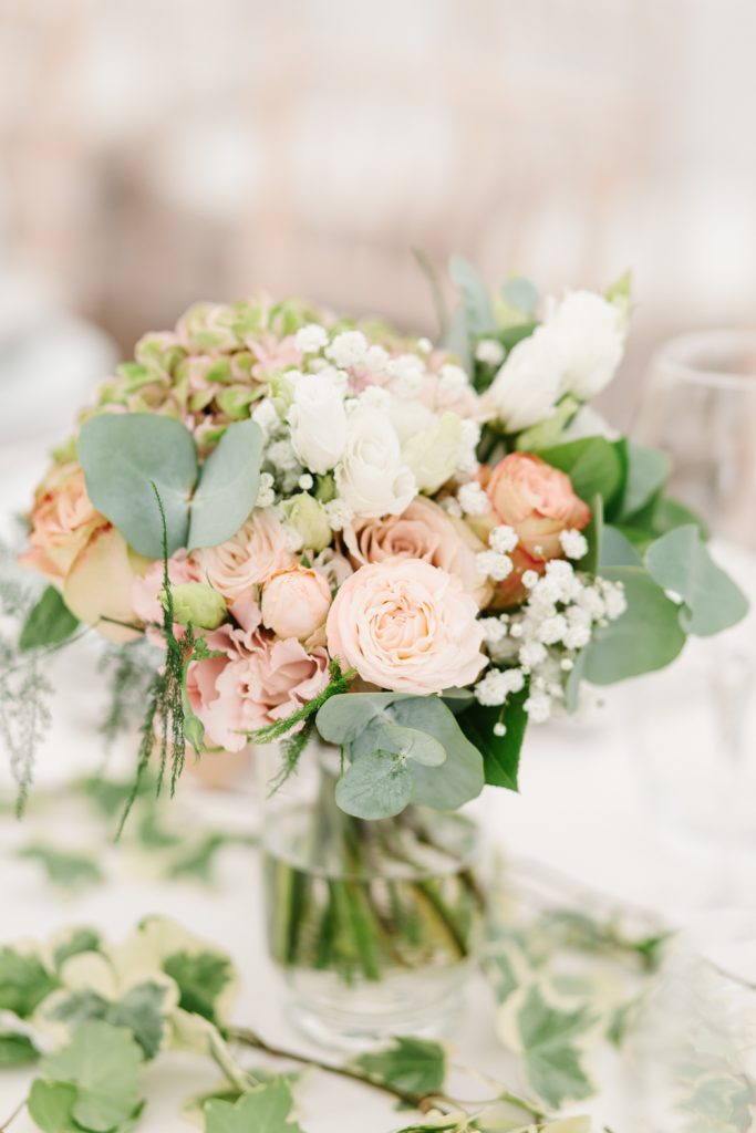 Table details by Cheshire wedding photographer at a Dorfold Hall wedding. Pretty rustic florals featuring roses and hydrangeas.
