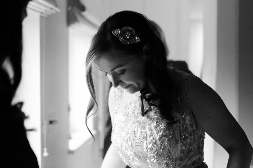 Bride wearing Jenny Packham Hermia gown getting ready at Farbridge Barns wedding.