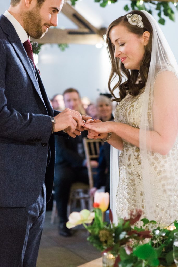 Glamorous winter barn wedding ceremony with bride in Jenny Packham gown.