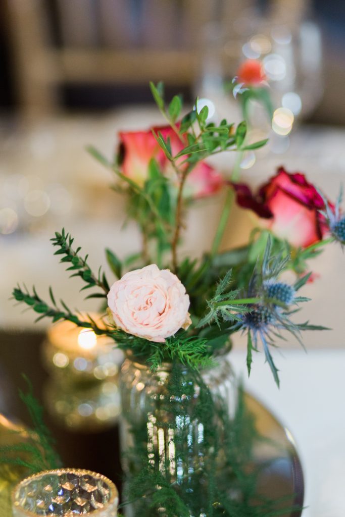 A winter wedding at Farbridge Barns featuring roses and candlelight.