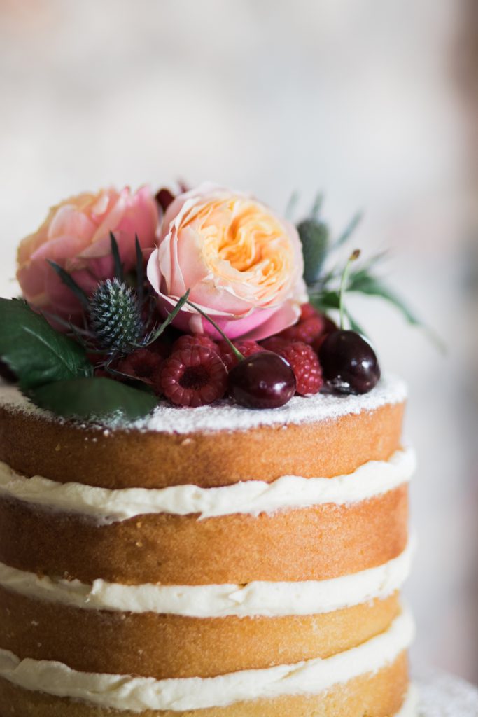 Naked wedding cake with natural flowers on top for a winter wedding at Farbridge Barns - photo