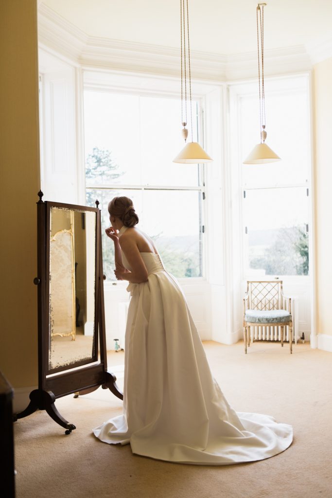 Bridal prep at Sandon Hall, Staffordshire. The bride wearing a Jesus Peiro wedding gown.