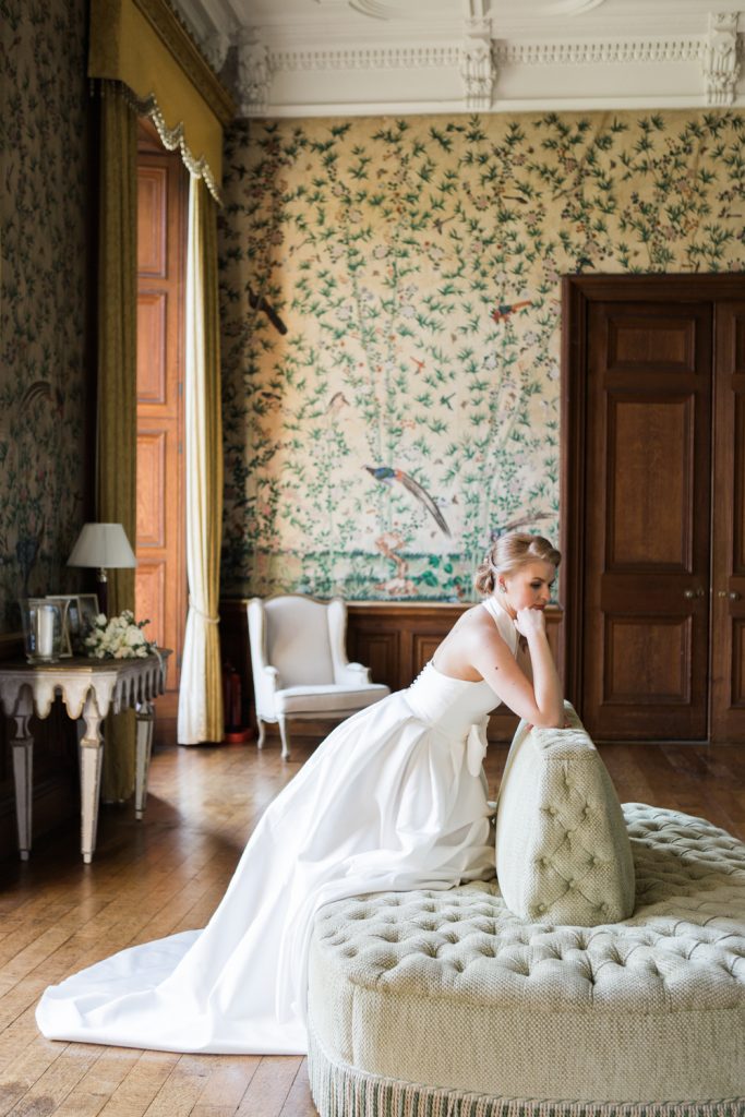 Bridal portrait at Sandon Hall, Staffordshire in the drawing room featuring Chinoiserie wallpaper