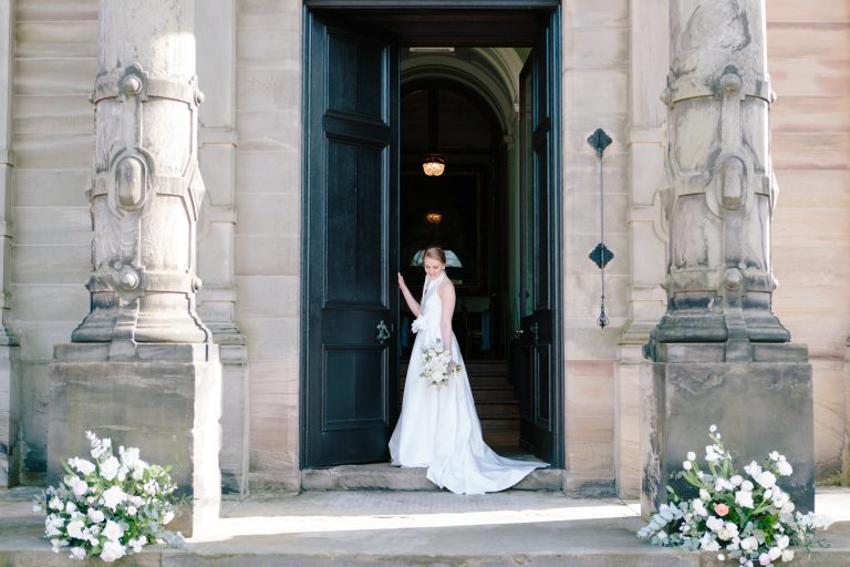 Bride at the door of Sandon Hall, wedding venue in Staffordshire for this bridal inspiration shoot featuring a Jesus Peiro wedding gown. Photography by Jade Osborne Fine art wedding photographer.