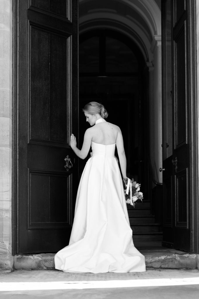 Bride at the door of Sandon Hall, wedding venue in Staffordshire for this bridal inspiration shoot featuring a Jesus Peiro wedding gown. Photography by Jade Osborne Fine art wedding photographer.