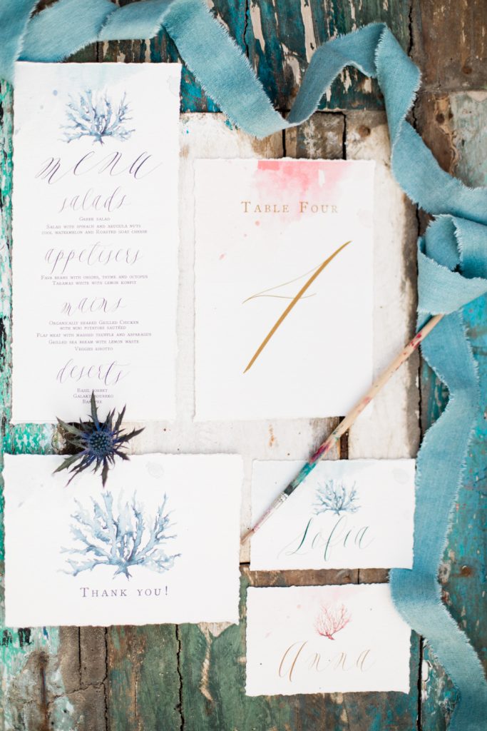 Blue and white calligraphy wedding stationery for a Santorini wedding photo