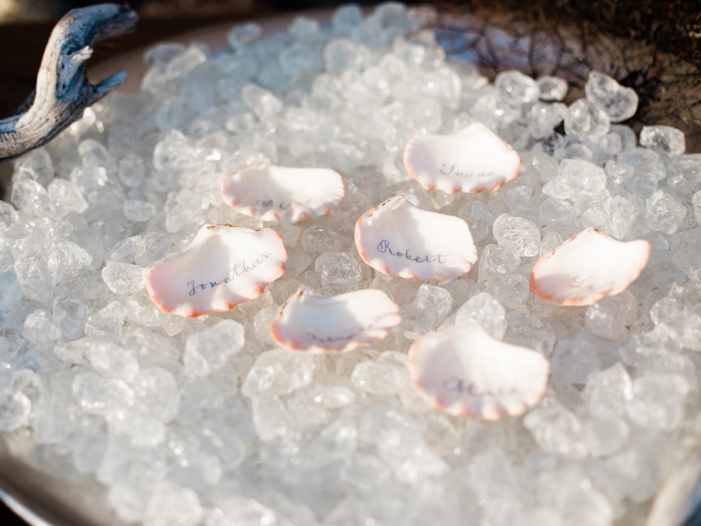 Shell escort cards for a beach wedding by UK Wedding Photographer