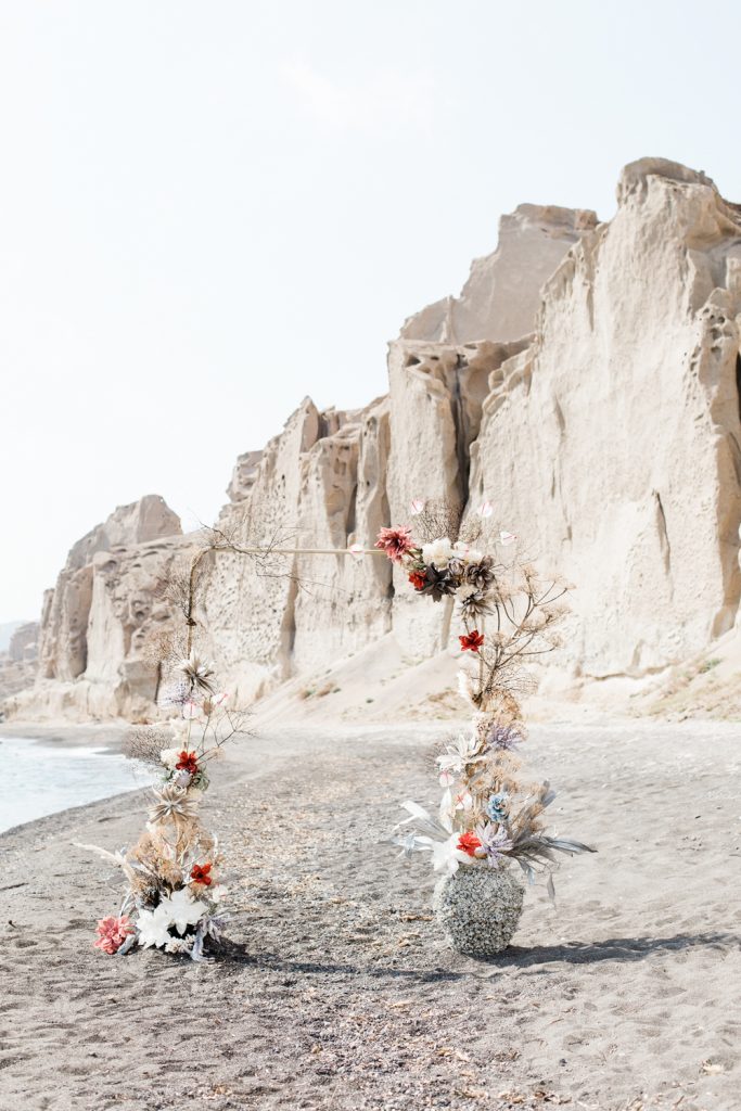 Floral arch on beach at Santorini wedding photo