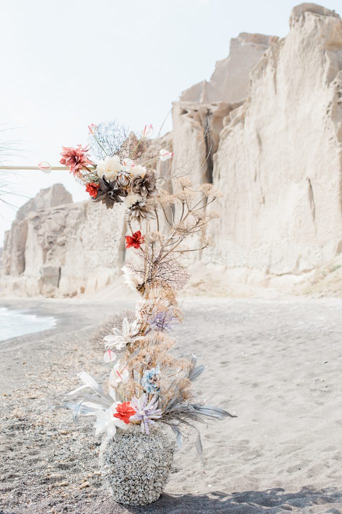Floral arch on beach at Santorini wedding photo