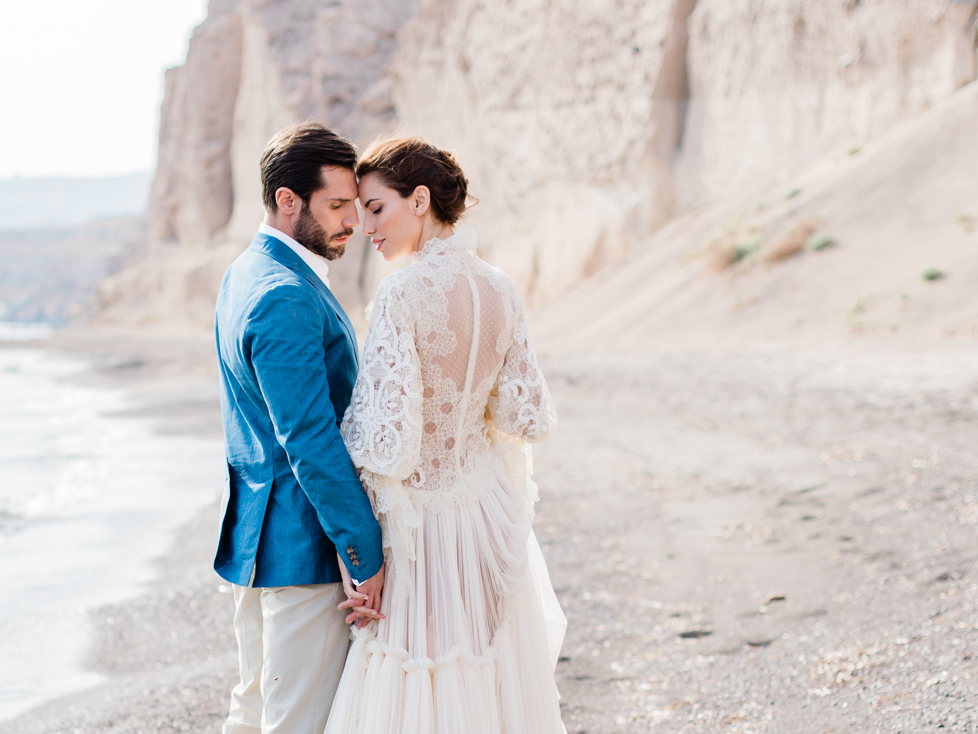 Bride and groom wedding photographs for a beach wedding by UK Fine Art Wedding Photographer