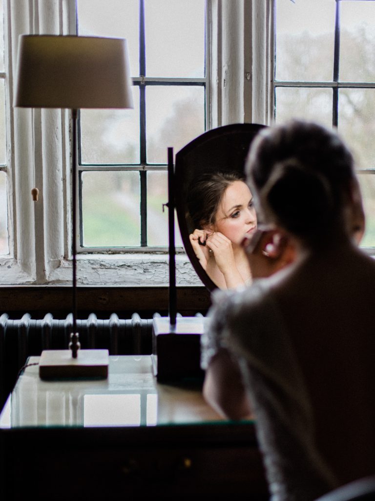 Bridal preparation featuring bride in Jenny Packham bridal for an elegant and intimate inspiration shoot at Dorfold Hall wedding venue in Cheshire