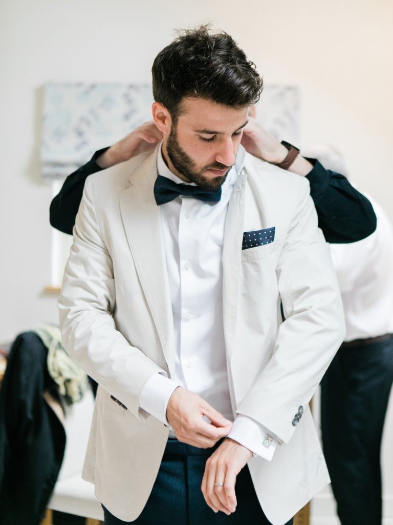Groom wearing Hugo Boss for a bow tie wedding by Cheshire Wedding Photographer