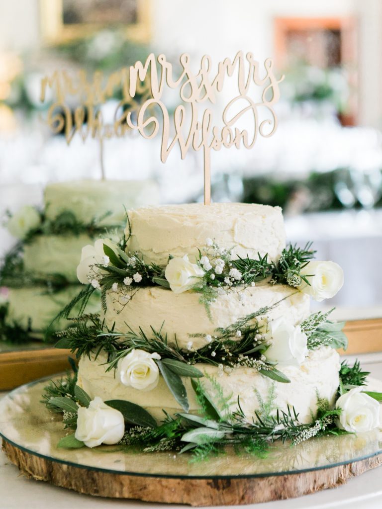 Rustic wedding cake with white flowers by UK Fine Art Wedding Photographer