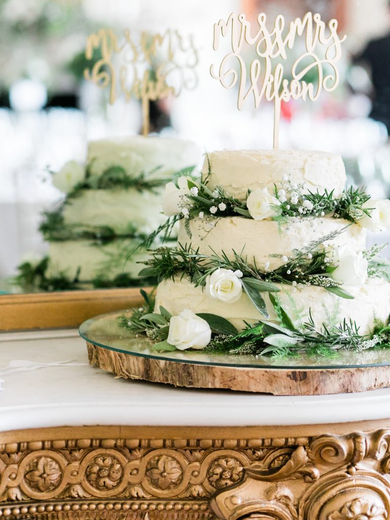 Rustic wedding cake with white flowers by UK Fine Art Wedding Photographer