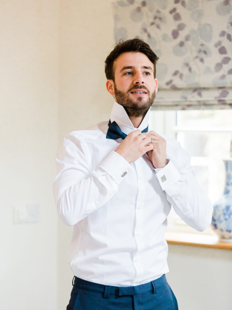 Groom wearing Hugo Boss for a bow tie wedding by Cheshire Wedding Photographer