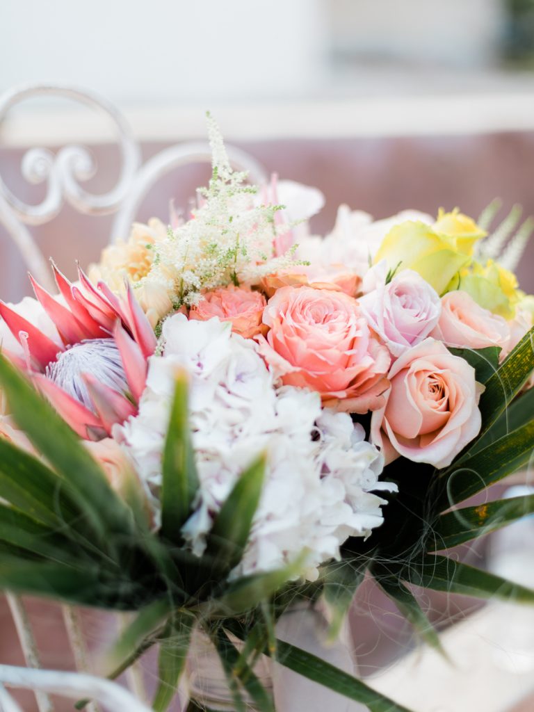 Coral wedding flowers for a Santorini wedding editorial shoot