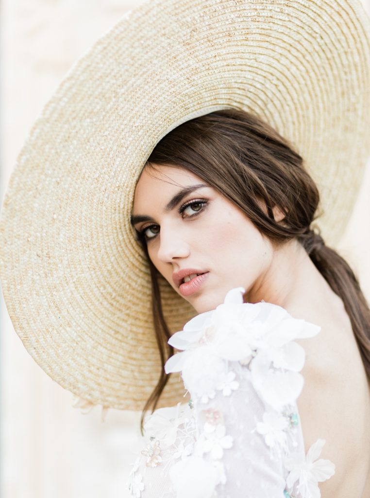 Bride wearing a hat for a Santorini editorial shoot