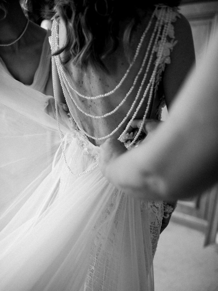 Bridal preparations featuring the back of a Galia Lahav Couture gown
