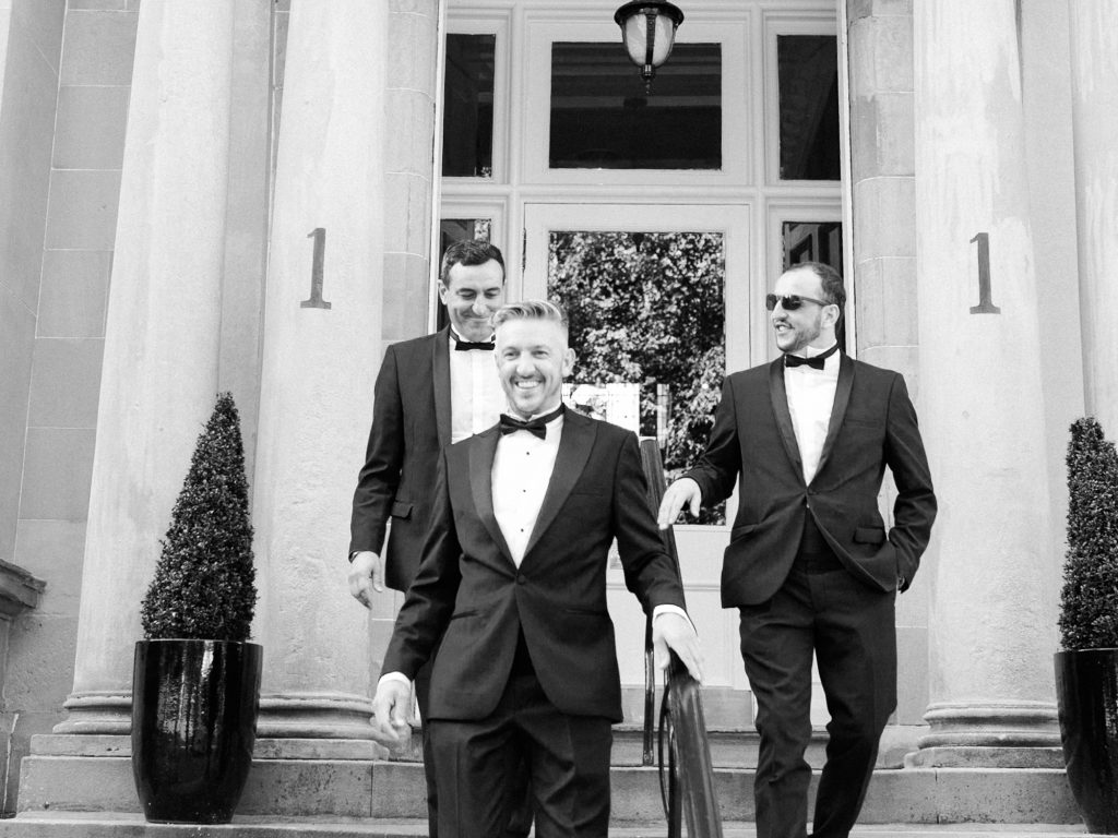 Groom with his groomsmen for a black tie city wedding