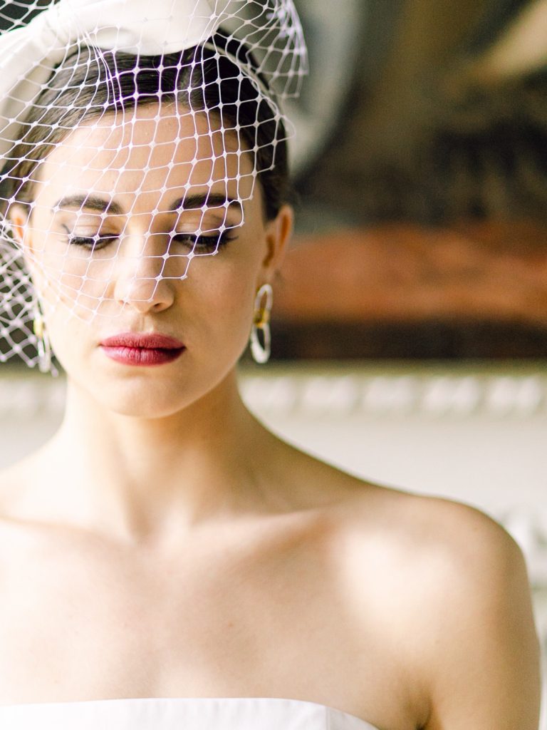 Bride wearing a birdcage veil by Awon Golding.
