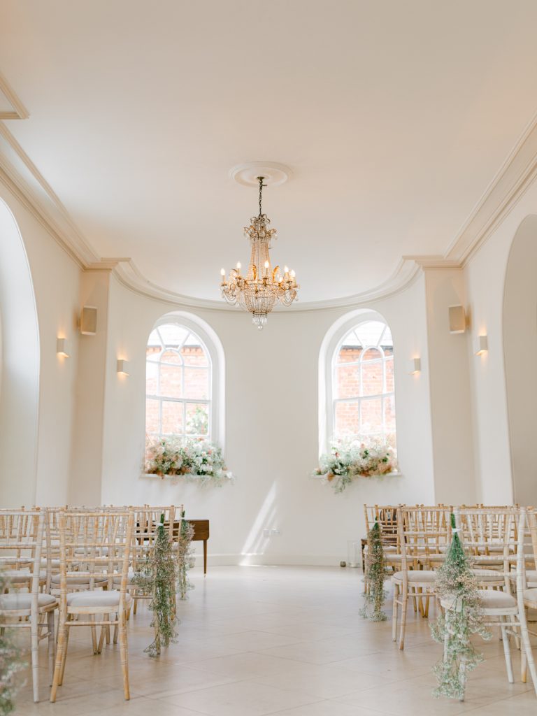 Iscoyd Park's wedding ceremony setting decorated with elegant neutral florals and bathed in natural light.