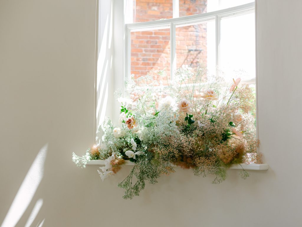 Detail shot of a floral installation on the window sill in the ceremony room.