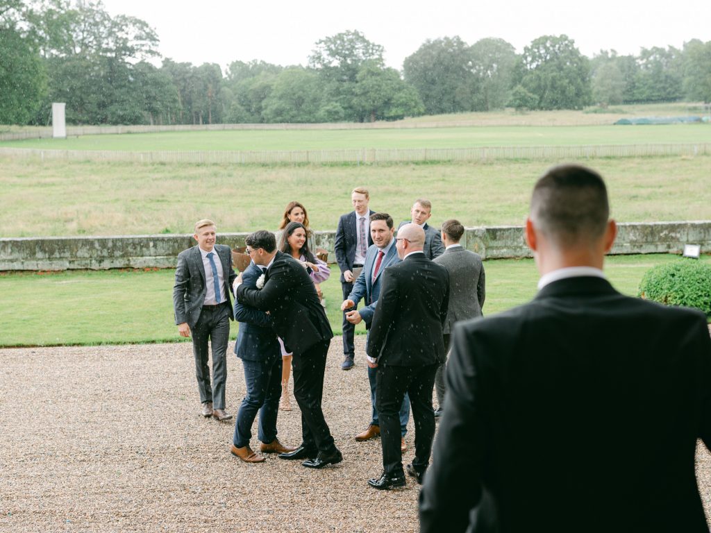 Wedding guests arrive at the front of Iscoyd Park, a country house wedding venue.