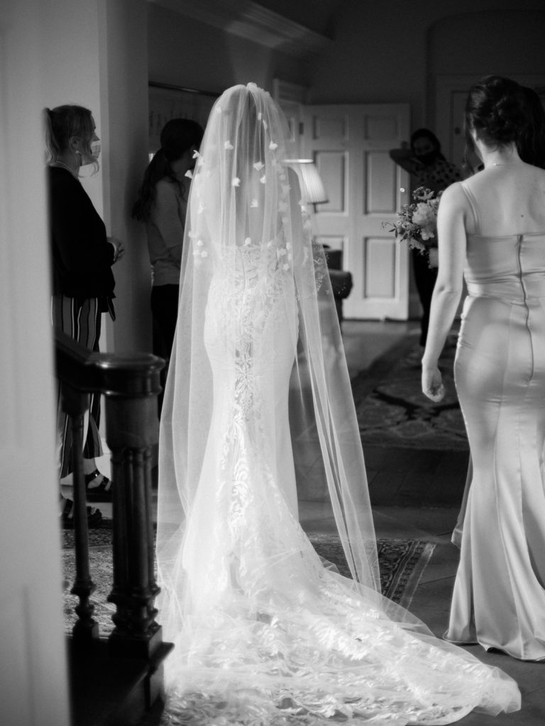 Black and white image of Erin getting ready to enter the ceremony room.