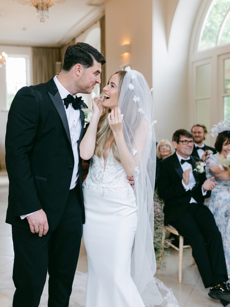 Erin smiles broadly at Ryan after their just-married kiss.