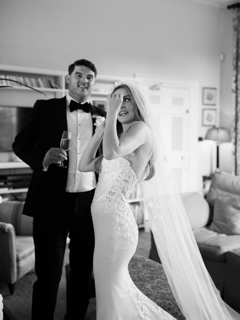 Erin fixing her veil before joining her wedding guests for confetti and the drinks reception.