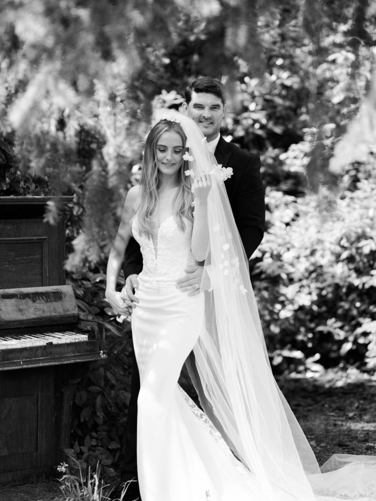 Couples portraits in the black, this is shot in black and white with Ryan standing behind Erin.