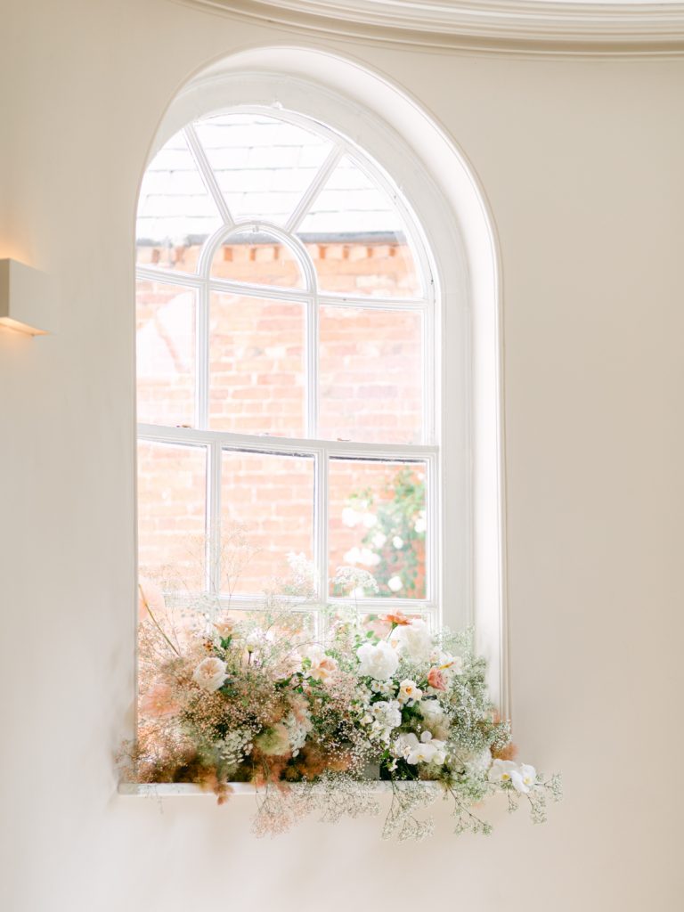 Detail shot of the elegant wedding florals on the window sill at Iscoyd Park.