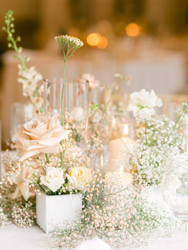 Detail shot of the tablescape. Gypsophila, roses, neutral table linen and candlelight.