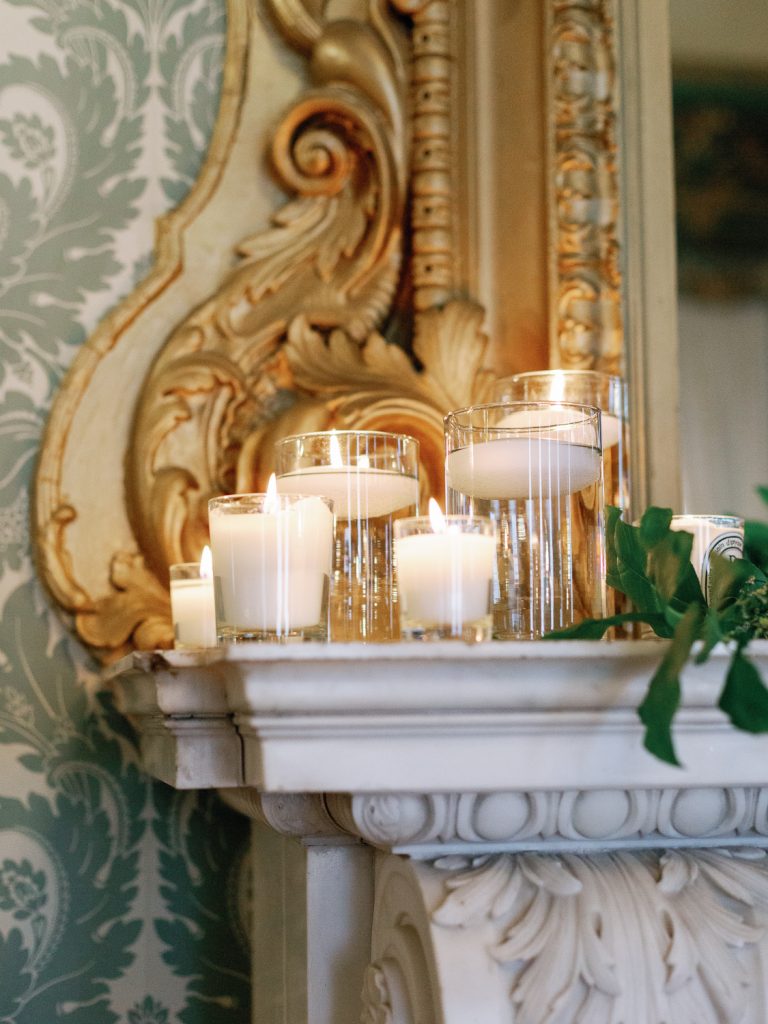 Beautiful lit candles on one of the mantlepieces