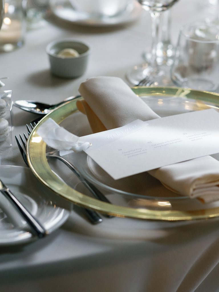 Close up detail shot of the tablescape, crockery, cutlery, linen and menu