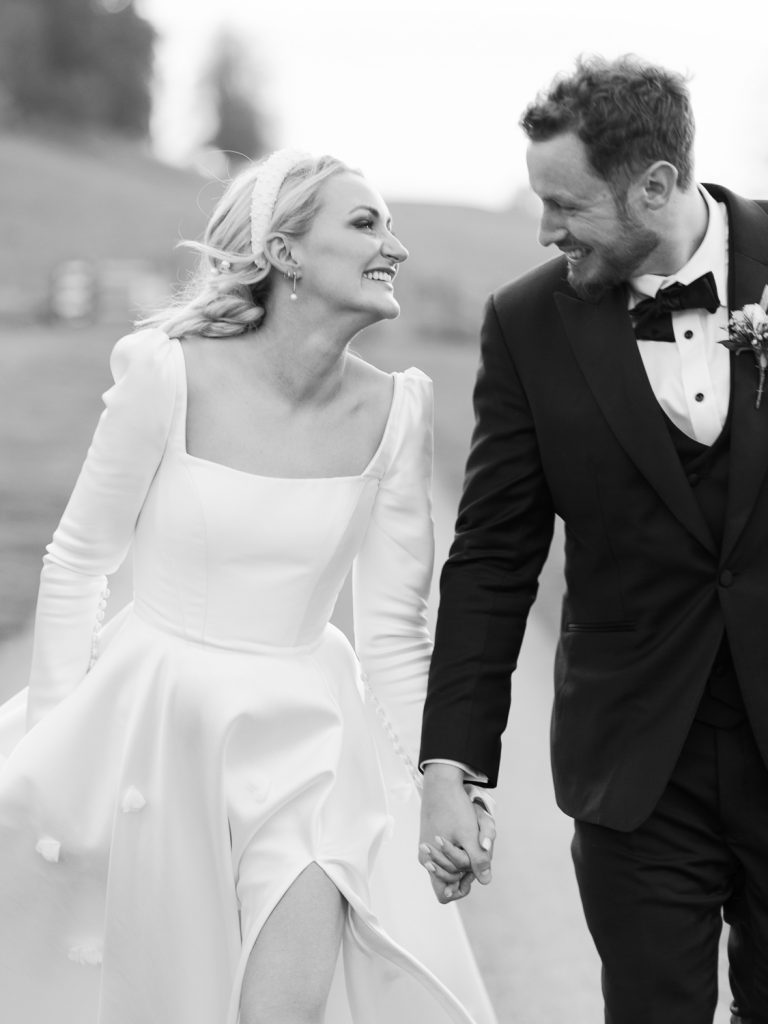 Couples taking a walk in the grounds together, holding hands and smiling