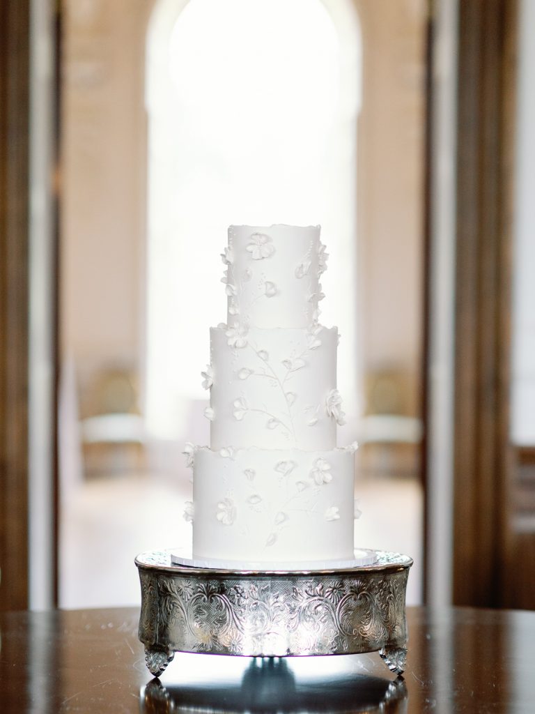 Elegant, white wedding cake on a silver stand