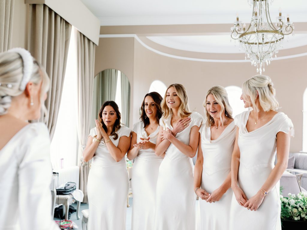 First look between bride Jessica and her bridesmaids