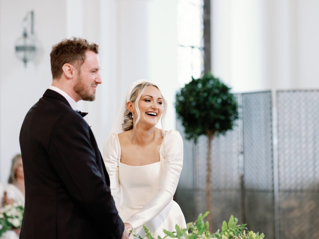 Couple exchanging wedding vows and smiling