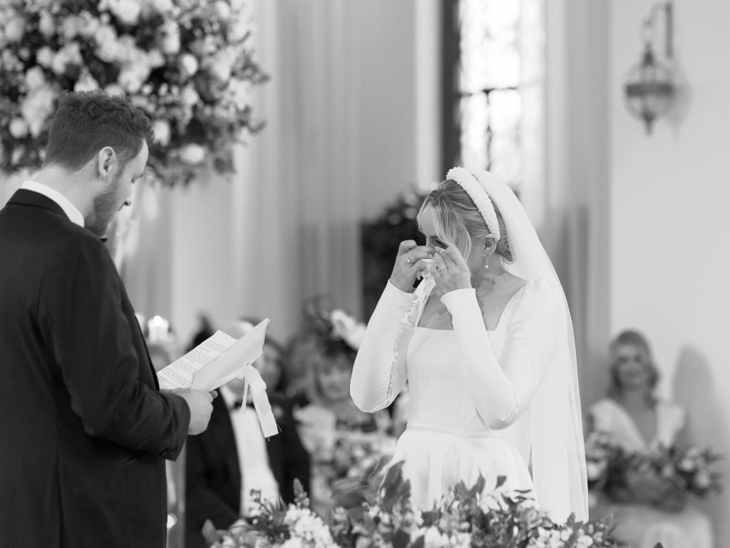 A tearful bride Jess dabs her tears during the wedding ceremony