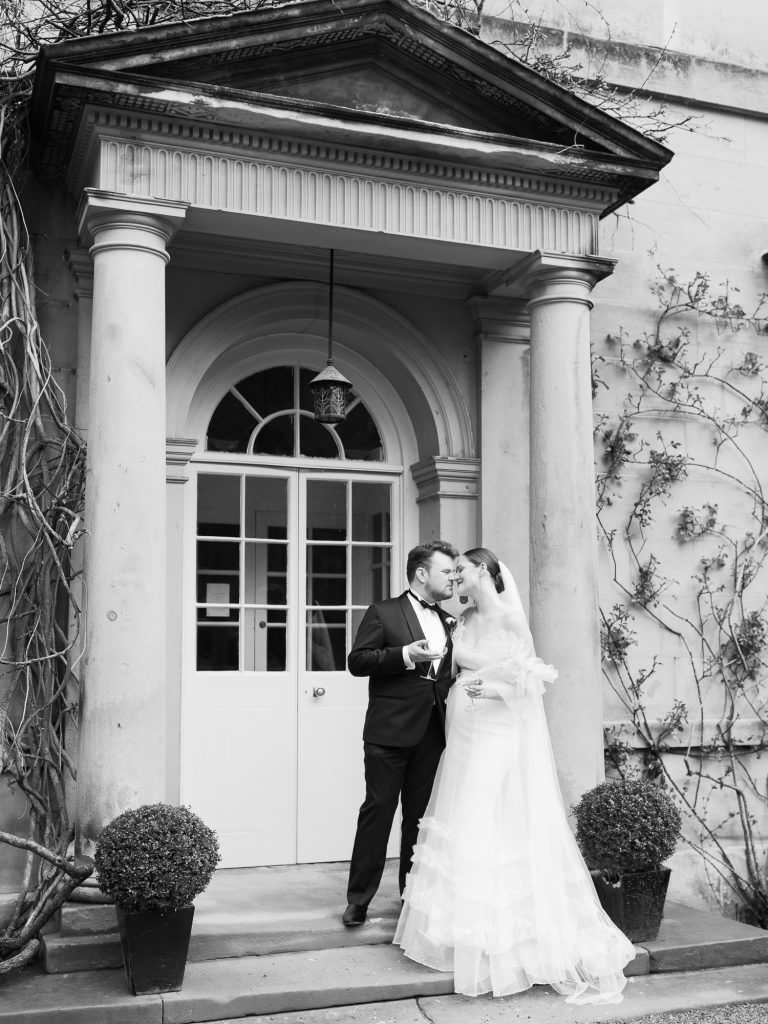 Bride and groom portrait outside the entrance to the Main House at Middleton Lodge.