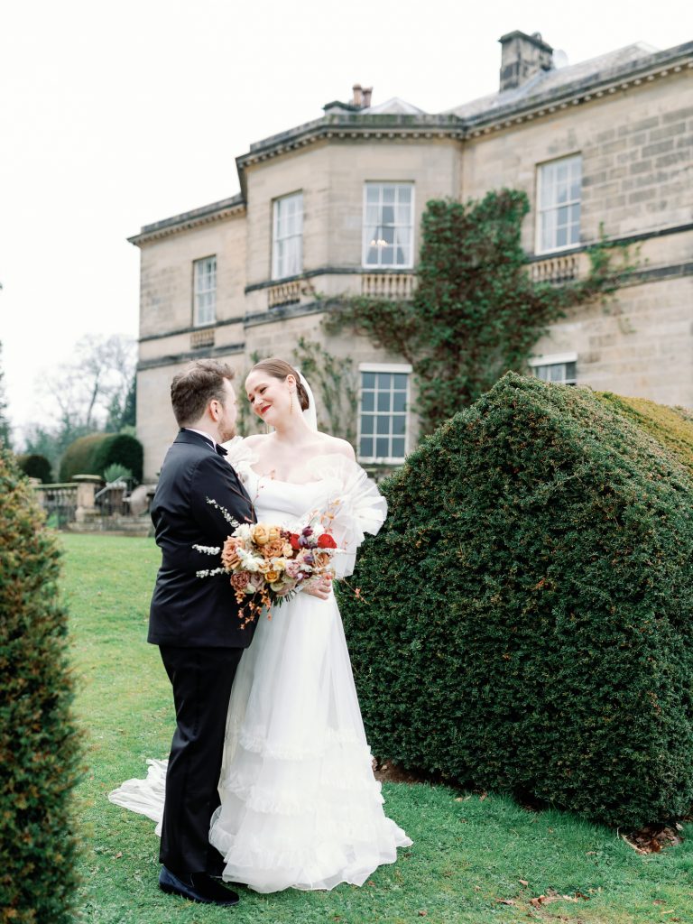 Bride and groom looking into each other's eyes in the gardens.